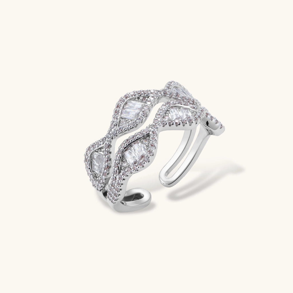 Layered adjustable ring with flowing wave design featuring baguette and round cubic zirconia stones in white gold plating
