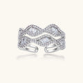 Layered adjustable ring with flowing wave design featuring baguette and round cubic zirconia stones in white gold plating