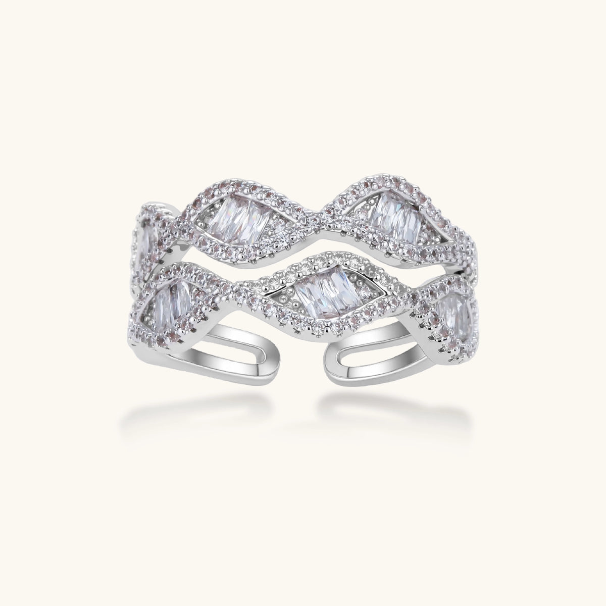 Layered adjustable ring with flowing wave design featuring baguette and round cubic zirconia stones in white gold plating