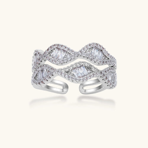 Layered adjustable ring with flowing wave design featuring baguette and round cubic zirconia stones in white gold plating